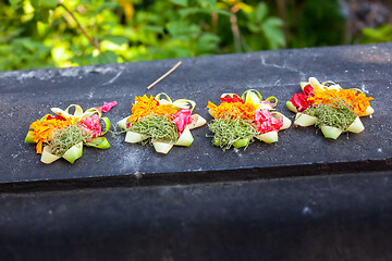 Image showing Votive offering with flowers, cookies and ribbons