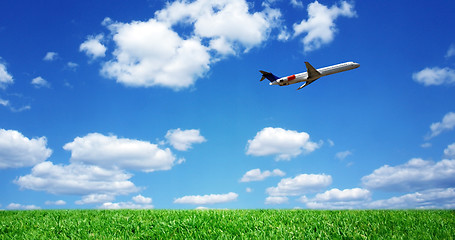 Image showing Airplane over grassy field