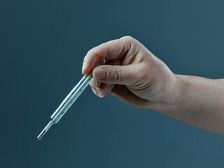 Image showing hand with thermometer