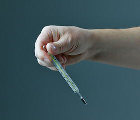 Image showing thermometer in human hand