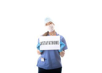 Image showing Nurse holding a sign to STAY AT HOME during virus COVID-19 pande