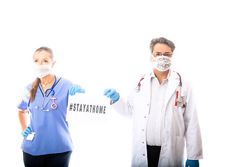 Image showing Two medical staff hold a sign during Coronavirus COVID-19 pandem