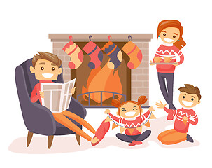 Image showing Family celebrating Christmas by the fireplace.