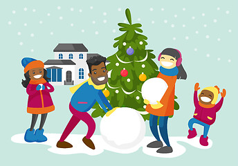 Image showing Multiracial family making a snowman in the yard.