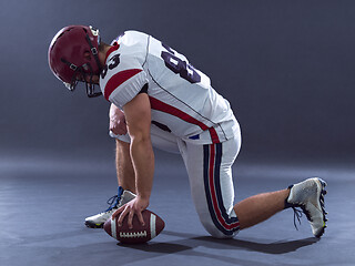 Image showing American football player getting ready before starting