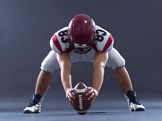 Image showing American football player getting ready before starting