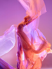 Image showing Ballerina. Young graceful female ballet dancer dancing over pink studio. Beauty of classic ballet.