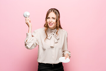 Image showing The serious frustrated young beautiful business woman on pink background