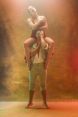 Image showing Flexible young modern dance couple posing in studio.