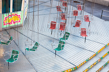 Image showing typical carousel with red and green chairs