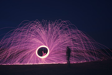 Image showing steel wool firework with shadow of a man