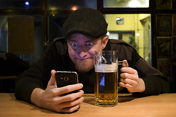 Image showing Guy and phone in the bar