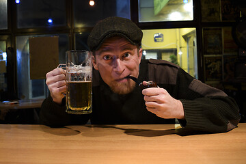 Image showing Guy smokes pipe in the bar