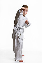 Image showing Karate boy hits with his right hand, white background