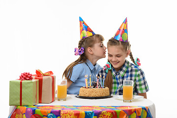 Image showing Girl on a birthday celebration says something else in the ear