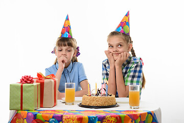 Image showing Two girls dream sitting at the festive table on the birthday