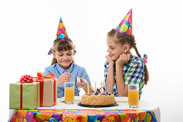 Image showing Children light a match to light candles on a cake on a holiday