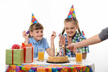 Image showing Children rejoice when mom lights candles at the birthday festive table