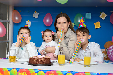 Image showing Family blowing in the reeds festive holiday horns