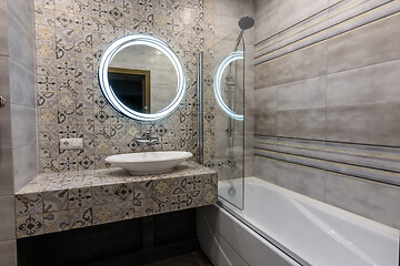 Image showing Washbasin, mirror and bathtub in the interior of a modern bathroom