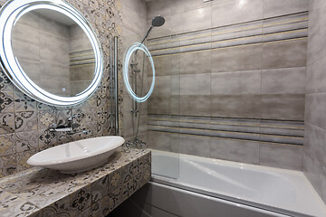 Image showing Beautiful modern bathroom, view of the washbasin and bathtub