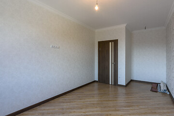 Image showing An empty room after repair, in the corner are the remains of building materials