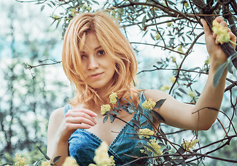 Image showing Young Blonde Woman Among Blossoming Trees