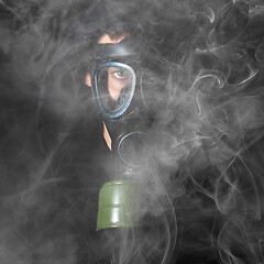 Image showing Man in a gas mask in the smoke