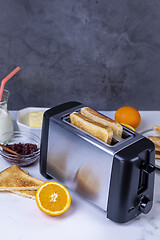 Image showing Slices of toast coming out of the toaster for healthy breakfast