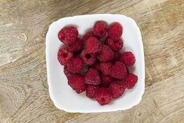 Image showing raspberries in a white plate on the table