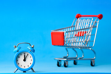 Image showing Clock in the foreground, a grocery cart blurry in the background