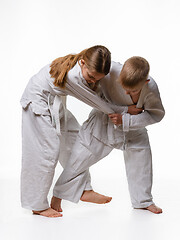 Image showing The boy is trying to make a cut for a girl in judo class