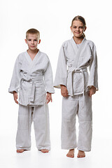 Image showing Full-length portrait of a boy and a girl of judo students