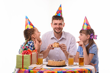 Image showing Children ask dad for a piece of holiday cake