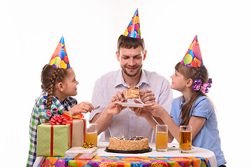 Image showing Children ask dad for their piece of holiday cake