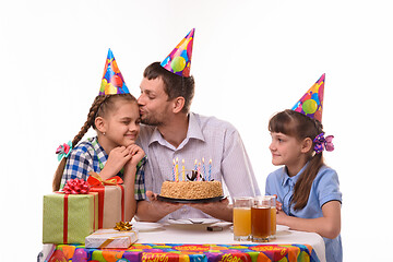 Image showing Children wish dad happy birthday, father kisses daughter