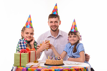 Image showing Kids and dad drink juice at a birthday party