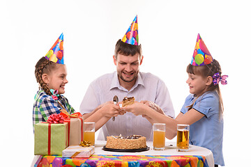 Image showing Children fight for the first piece of birthday cake