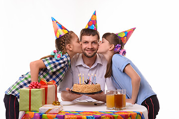 Image showing Children congratulated father on his birthday and kiss him on the cheek