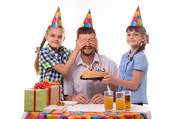 Image showing Two sisters prepared a surprise for dad and closed his eyes