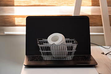 Image showing Conceptual photo with miniature shopping-basket and wc paper. Safety internet shopping.