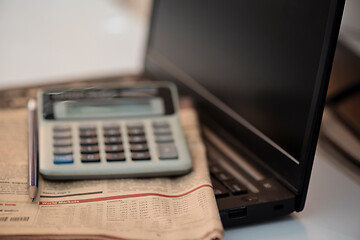 Image showing Black notebook, calculator and finance newspaper. Coronavirus concept. Work from home concept