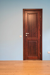 Image showing Frontal view to the wooden door in home interior