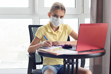 Image showing A sick quarantined girl remotely learns and looked in frame