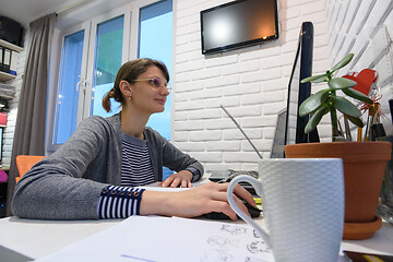 Image showing Freelancer girl works at home at her workplace