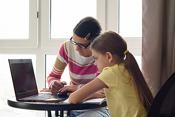 Image showing Mom and daughter are surfing the web together at home.