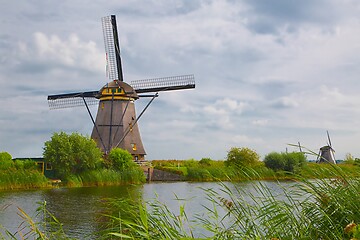 Image showing Windmill beside a canal