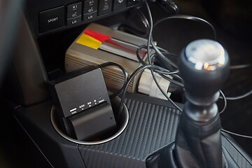 Image showing Charging camera batteries in a car