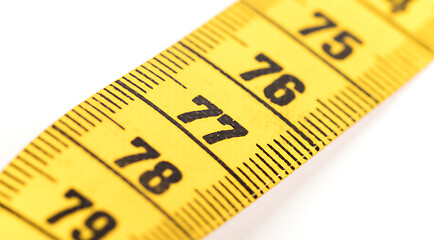 Image showing Close-up of a yellow measuring tape isolated on white - 77