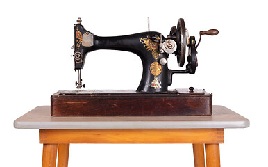 Image showing Antique, vintage sewing machine on an old table